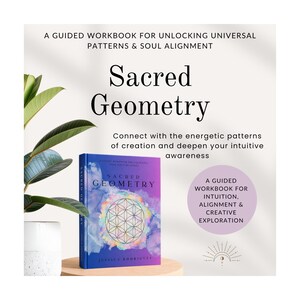 May include: A book titled "Sacred Geometry" with a colorful cover featuring a geometric design. The book is displayed on a wooden stand with text that reads "A guided workbook for unlocking universal patterns & soul alignment."