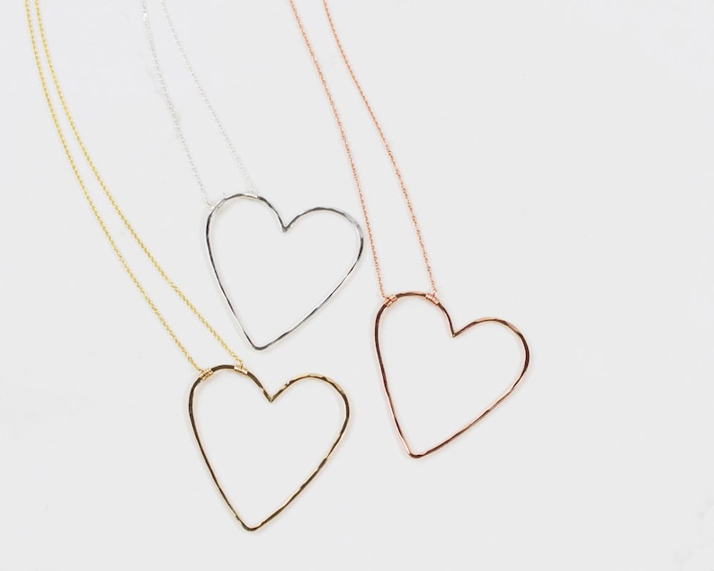 Our design is delightfully asymmetrical, just like being swept off your feet. The bold 1.75 X 1.75 inch heart pendant is wire wrapped to our barely there 1.1mm chain. You have the choice of 3 fine metal styles for your heart necklace as shown here.