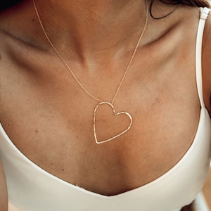 Exquisitely handcrafted with elevated materials, this unique open heart necklace will make the perfect gift for her! Our design is delightfully asymmetrical. Shown here in 14 karat yellow gold filled, it is sure to sweep her off her feet.