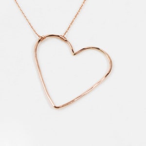 Image shows our 14 karat rose gold filled sweet heart necklace. The purposefully asymmetrical design is playful, fun and unique. Get prepared to sweep her off her feet with this beautifully handmade and expertly crafted design with elevated materials