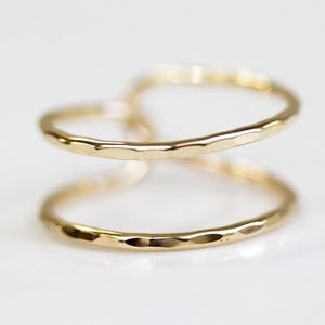 Two gold-colored rings are shown against a white background.