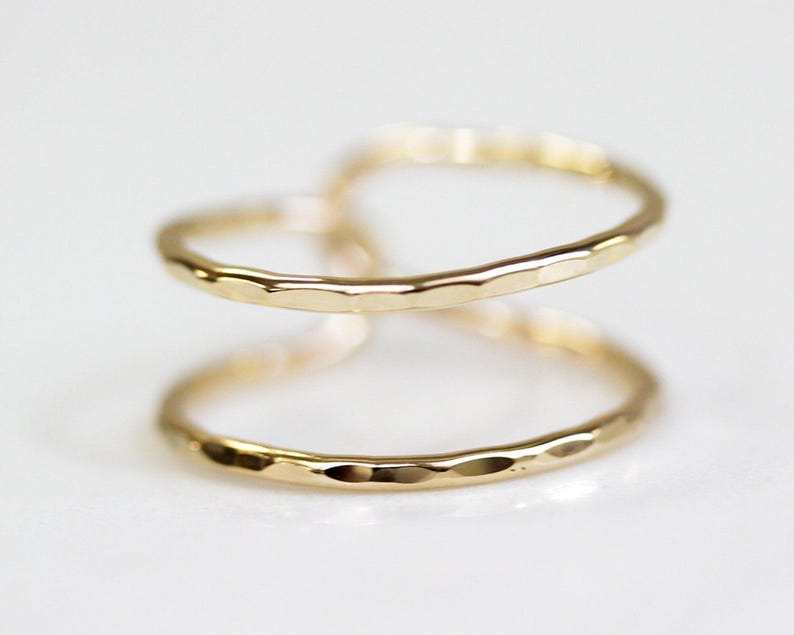 Two gold-colored rings are shown against a white background.