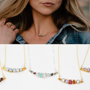 Images shows what the our mothers birthstone necklace looks like on a model with samples of different metals and numbers of stones. Raw, organic, personalized, these necklaces are totally unique and custom and make the best personalized mom gift.