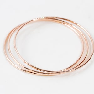 Each fine metal bangle bracelet is handcrafted from 14 karat Rose Gold Filled. This exquisite material is nickel free and perfect for sensitive skin. A hand hammered texture gives them their special sparkle. Grab one or several to stack. Great gifts.