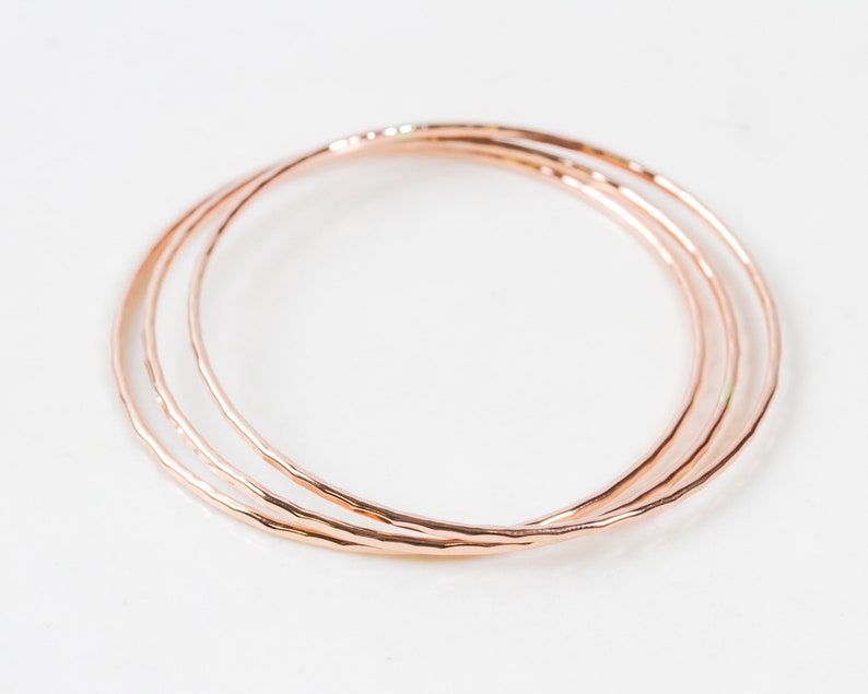 Each fine metal bangle bracelet is handcrafted from 14 karat Rose Gold Filled. This exquisite material is nickel free and perfect for sensitive skin. A hand hammered texture gives them their special sparkle. Grab one or several to stack. Great gifts.