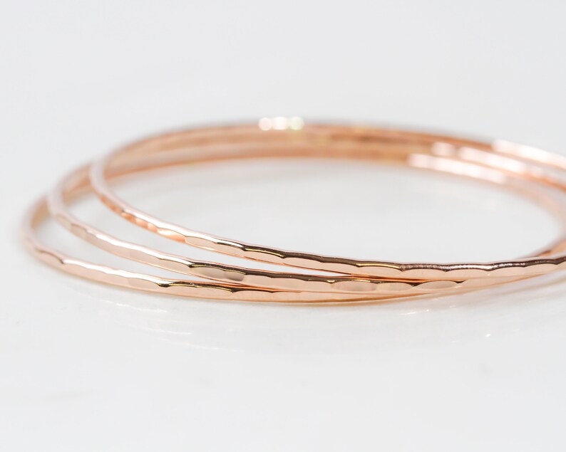 Each fine metal bangle bracelet is handcrafted from 14 karat Rose Gold Filled. This exquisite material is nickel free and perfect for sensitive skin. A hand hammered texture gives them their special sparkle. Grab one or several to stack. Great gifts.