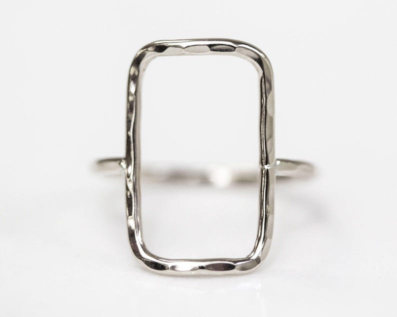 A simple silver ring with a rectangular cutout in the center.