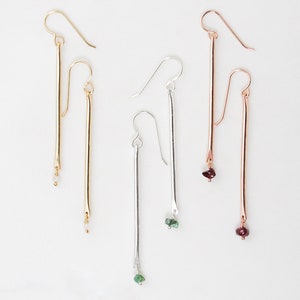Personalized Birthstone Bar Earrings offered in all three fine metal selects of 14 karat gold and rose gold filled and sterling silver. Delicate and everyday wearable, select your birthstone to dangle at the bottom of the skinny handmade bar.