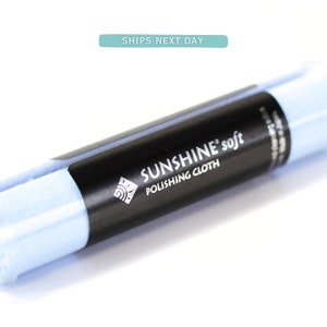 May include: A blue microfiber polishing cloth in a clear plastic tube with a black label that reads "SUNSHINE® soft POLISHING CLOTH".