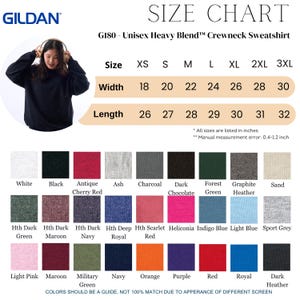May include: A black Gildan G180 unisex heavy blend crewneck sweatshirt. The size chart shows measurements in inches, with widths from 18 to 30 inches and lengths from 26 to 32 inches. Color options include white, black, and various heathered shades.