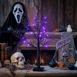 May include: A Halloween-themed display featuring a black tree with purple lights, a skull, pumpkins, and a tombstone. A Scream mask and books are also present, creating a spooky atmosphere. The scene is set on a fireplace mantel.