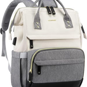 May include: A two-tone backpack featuring a cream-colored upper section and a heather gray lower section with a black base. It includes top carry handles, adjustable shoulder straps, gold-tone zippers, and a small gold logo plate reading Lovevook.
