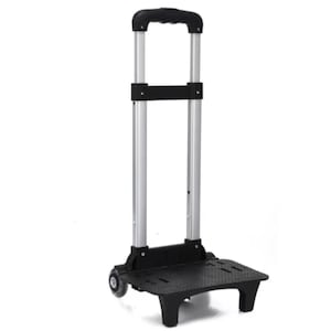 May include: A black and silver rolling luggage cart with a retractable handle. The cart has a black base with two small wheels and a silver telescoping handle with a black grip. The cart is designed for easy transport of luggage or other items.