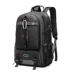 May include: A black backpack featuring multiple zippered compartments, side mesh pockets, and adjustable shoulder straps. The front includes a silver carabiner, red stitching accents, and a black oval patch with the white text LORCA printed on it.