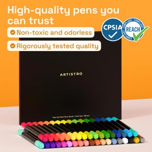 May include: A set of 36 dual-tip paint pens with brush and fine tips, arranged in a rainbow of colors. The pens are displayed in front of a black box with the brand name "ARTISTRO". The text "High-quality pens you can trust" is visible.
