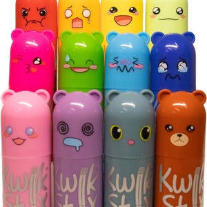 May include: A collection of colorful Kwik Stix paint sticks with bear-shaped caps, each displaying a different facial expression. The paint sticks are in various colors, including red, yellow, green, blue, pink, purple, gray, and brown. The text "Kwik Stix" is printed on the body of each stick.