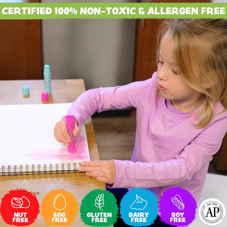 May include: A young person in a pink long-sleeved shirt uses a pink marker on a white spiral-bound sketchbook. The image includes text that reads "CERTIFIED 100% NON-TOXIC & ALLERGEN FREE" and icons indicating the product is nut, egg, gluten, dairy, and soy free.