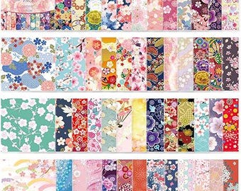 May include: A collection of decorative paper sheets featuring diverse Japanese-inspired patterns including cherry blossoms, chrysanthemums, geometric shapes, and fans in vibrant colours like pink, red, blue, gold, and green, labelled as a Paper Pack.