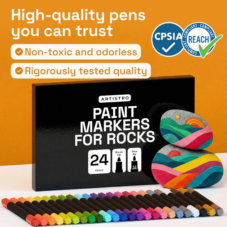 May include: A black box of Artistro paint markers for rocks with 24 colors, brush and fine tips. The image shows two painted rocks with colorful designs and a row of colored markers. The text says "High-quality pens you can trust."