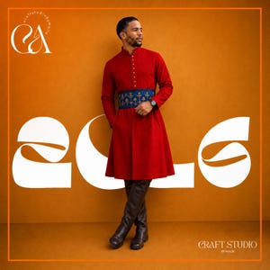 May include: A long-sleeved red tunic featuring a mandarin collar with a vertical row of buttons, a blue embroidered waistband with gold floral patterns, and dark brown knee-high boots. The garment is worn by a person against an orange background.