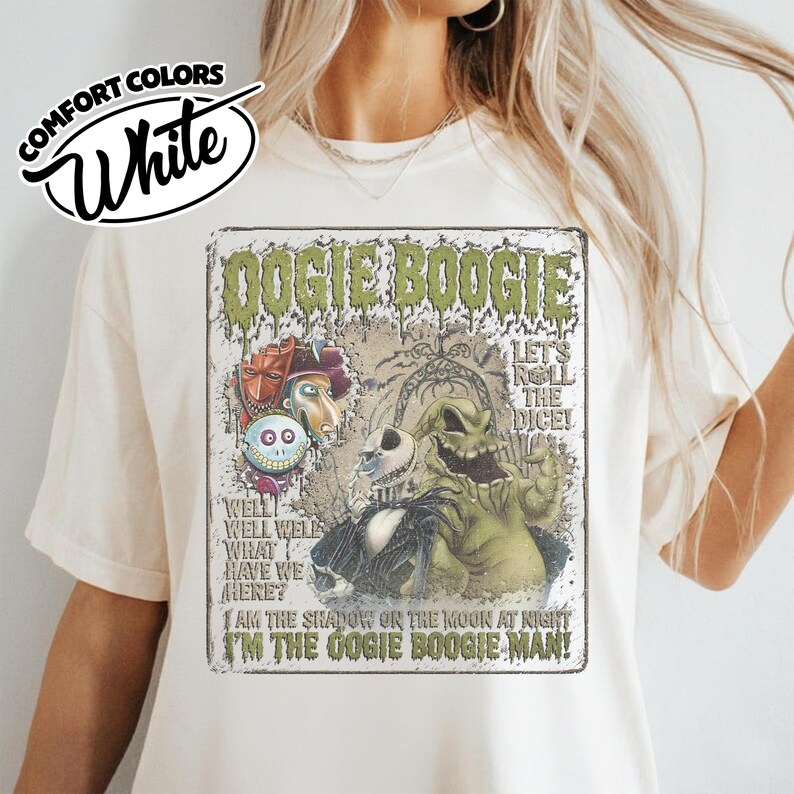 May include: White Comfort Colors t-shirt featuring a graphic of Oogie Boogie from The Nightmare Before Christmas. The design includes the text "DOGIE BOOGIE" and other phrases like "I'M THE OOGIE BOOGIE MAN!" and "LET'S ROLL THE DICE!"