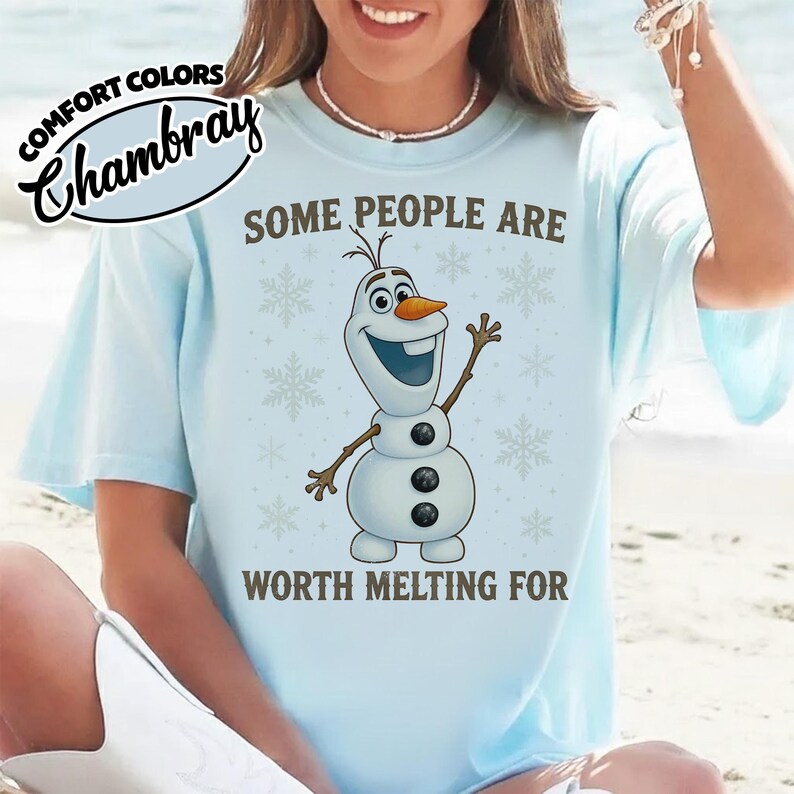 May include: Light blue t-shirt with the text "SOME PEOPLE ARE WORTH MELTING FOR" and a graphic of Olaf the snowman. The shirt also has the words "COMFORT COLORS" and "Chambray" printed on it.