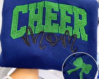 Sudadera personalizada con bordado de purpurina y lazo lateral para animadoras, ideal como regalo para el día del partido.