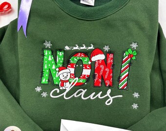 Sudadera navideña personalizada con bordado de Noni y Nana Claus, suéter navideño bordado con el texto "Mamá" y "Ammy".