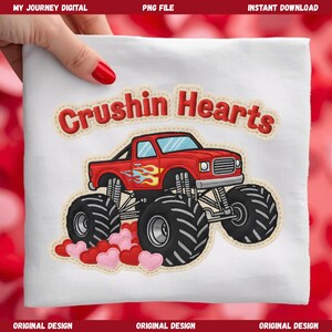 May include: White t-shirt featuring a red monster truck with flames and the text "Crushin Hearts." The truck has large black tires and is surrounded by pink and red hearts. The design is an original digital creation.