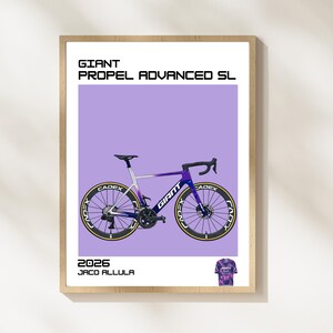 May include: A framed poster featuring a Giant Propel Advanced SL bicycle illustration. The bike is purple and white with black wheels and the Cadex logo. The poster includes the text "2026 JACO ALLULA" and a small jersey graphic.