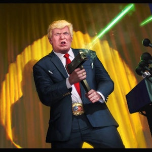 May include: A man in a dark blue suit and red tie holds a silver object in front of a yellow and red American flag. He is standing in front of a podium with microphones. The background is a yellow and red curtain.