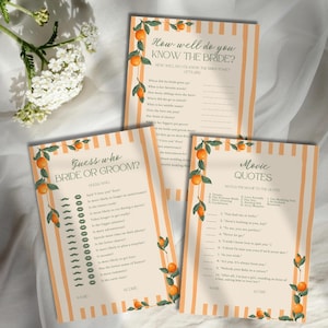 May include: Three wedding game cards featuring orange and white vertical stripes with orange fruit and green leaf illustrations. The cards are titled How well do you know the bride, Guess who bride or groom, and Movie quotes with printed text.