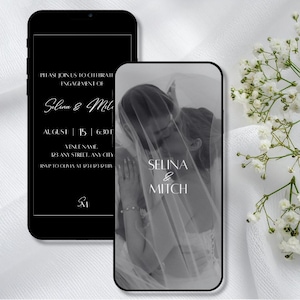 May include: Two smartphones display a black and white engagement announcement. One shows the text "Selina & Mitch" with event details. The other features a grayscale photo of a couple kissing under a veil. White flowers and fabric are in the background.
