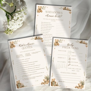 May include: Three beige paper game cards for a baby shower featuring brown teddy bear illustrations and floral accents. The cards are titled Who Knows Mama Best, Kid's Movie Quotes, and Baby Predictions, with printed lines and text for guests to fill in.