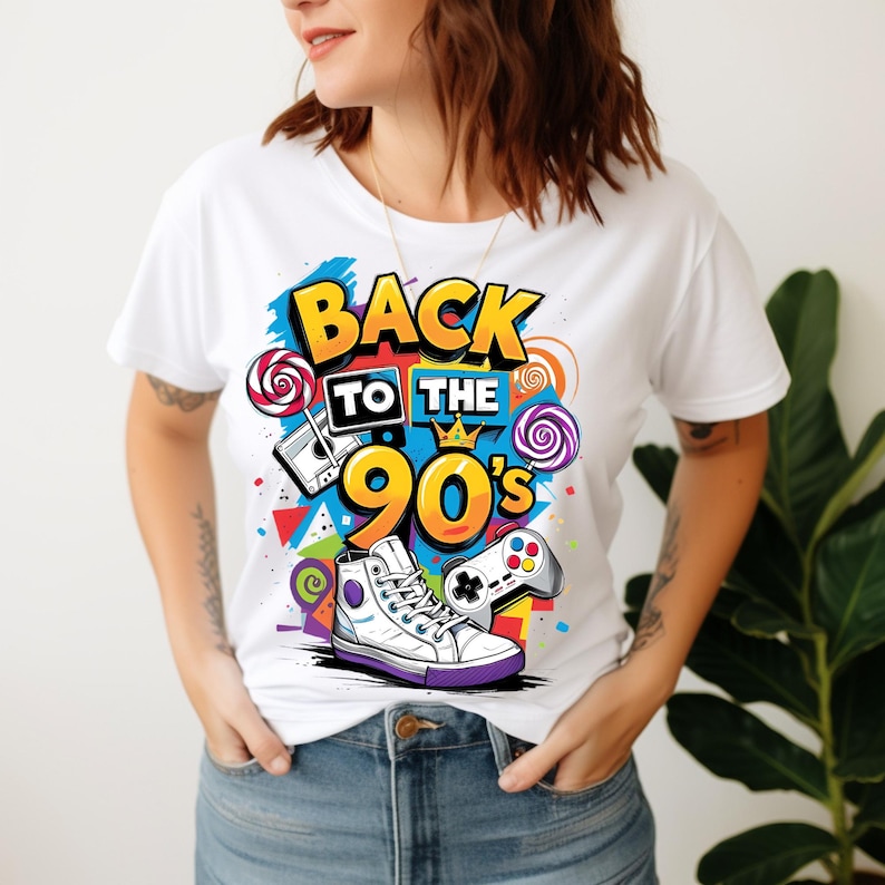 May include: A white short-sleeved t-shirt featuring a colourful graphic print with the text BACK TO THE 90'S. The design includes a cassette tape, a game controller, a high-top sneaker, and lollipops, all rendered in vibrant yellow, blue, and purple.
