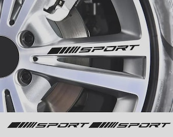 May include: Close-up of a silver car wheel with the word "SPORT" in black, along with a series of black lines. Below the wheel are two additional sets of the same design, each with the word "SPORT".