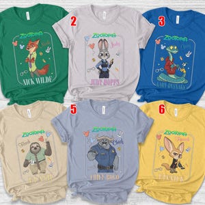 Puede incluir: Seis camisetas coloridas con personajes de la pel&iacute;cula animada "Zootr&oacute;polis". Cada camiseta muestra un personaje diferente, incluyendo a Nick Wilde, Judy Hopps, Gary, Flash, Chief Bogo y Finnick, con sus nombres impresos debajo.