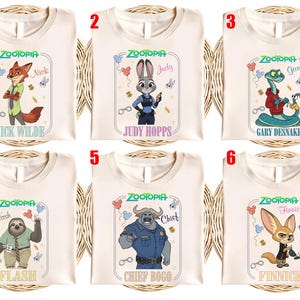 Puede incluir: Seis camisetas color crema con personajes de la pel&iacute;cula animada "Zootopia". Cada camiseta muestra un personaje diferente: Nick Wilde, Judy Hopps, Gary Desnake, Flash, Chief Bogo y Finnick, con sus nombres debajo. Las camisetas tienen cuello redondo.