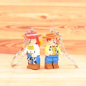 Custom Anime Character Toy Cowboy Woody and Cowgirl Jessie Keychain Inspired by Legendary Anime Movie