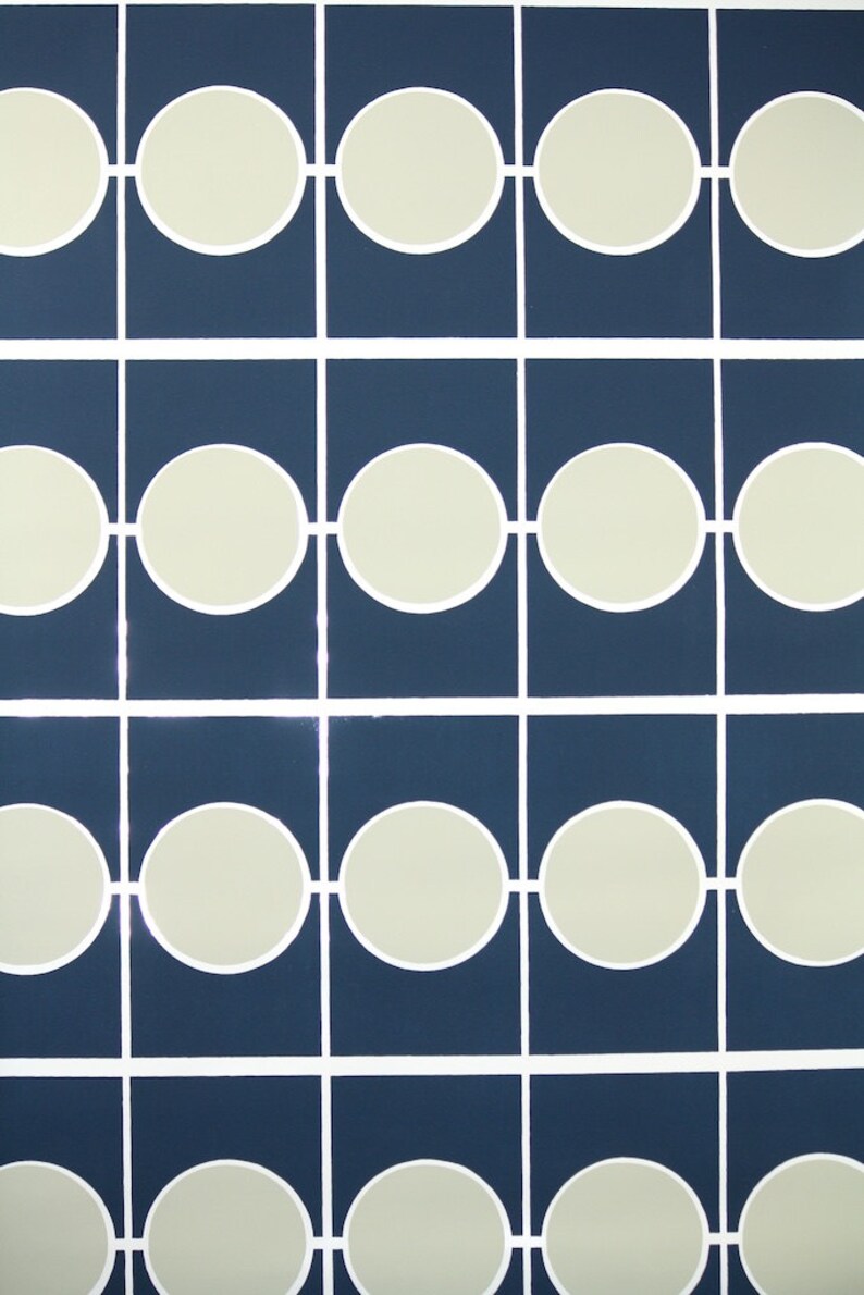 May include: Abstract geometric pattern. Navy blue squares are arranged in a grid, each containing an off-white circle. White lines connect the circles, creating a repeating design, ideal for wallpaper.