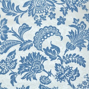 May include: A white background with a blue floral pattern. The pattern features stylized flowers, leaves, and vines.