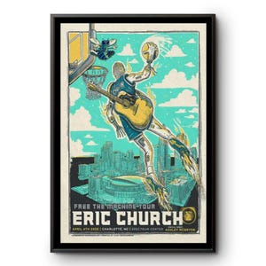 May include: A framed poster featuring a stylized illustration of a basketball player with a guitar, flames, and a cityscape. The poster includes the text "FREE THE MACHINE TOUR" and "ERIC CHURCH" with event details. The color palette includes teal, yellow, and blue.
