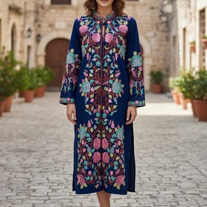 May include: A navy blue embroidered dress with a floral design in pink, green, and teal. The dress has long sleeves, a high collar, and a front zip. The embroidery is detailed down the front and on the sleeves.