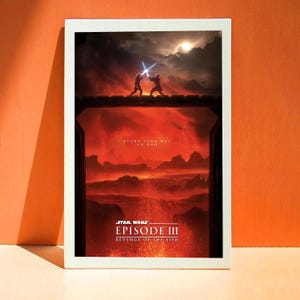May include: A framed Star Wars Episode III: Revenge of the Sith film poster. The poster depicts a dramatic scene with two figures duelling with lightsabers, set against a fiery, volcanic landscape. Text includes "EVERY SAGA HAS AN END".