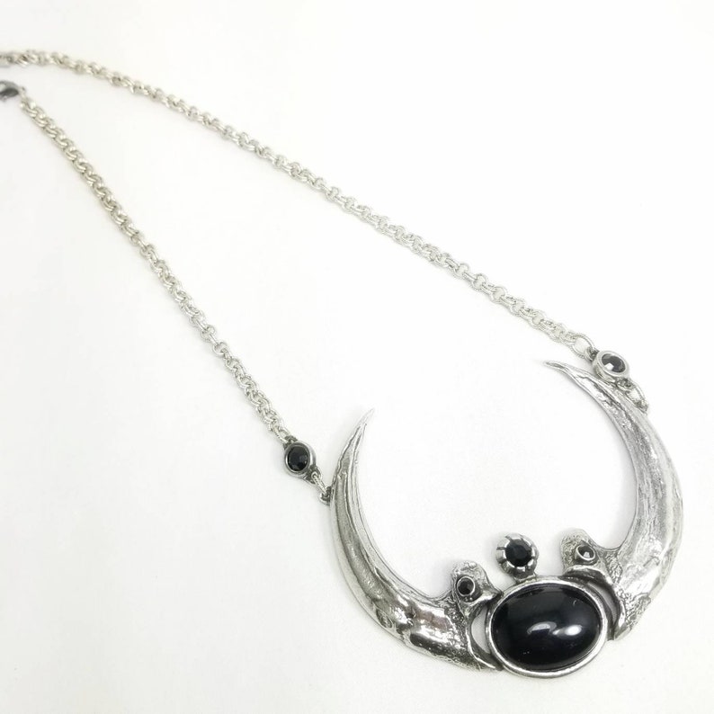 Harpy Eagle Claw Necklace with black glass.