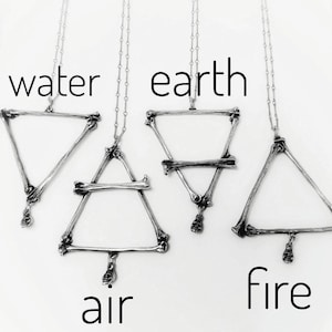 May include: Four silver necklaces with triangle pendants representing the four elements: water, earth, air, and fire. Each pendant is made of interconnected bone-like shapes.