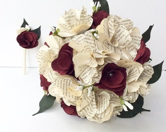 May include: A bouquet of cream and burgundy paper roses made from book pages. The bouquet is accented with small white flowers and green leaves. A matching boutonniere is included.