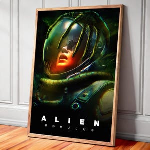 May include: A framed poster featuring a science fiction artwork. The image depicts a person in a space helmet with a cracked visor, and a creature's appendage reaching towards the face. The poster has the text "ALIEN ROMULUS" at the bottom.