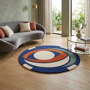 May include: A circular area rug featuring a bold geometric design with a large central cream circle surrounded by concentric arcs in burnt orange, sage green, and deep navy blue, all set against a dark blue background with cream accents.