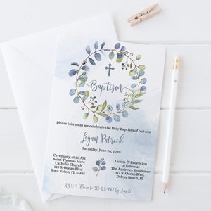 May include: A blue and green watercolor wreath with a cross in the center and the word "Baptism" written in cursive. The invitation is for a baptism ceremony for Logan Patrick on Saturday, June 26, 2020. The ceremony will be held at Saint Thomas More Catholic Church at 123 S. Ocean Blvd. in Boca Raton, FL 33425. A lunch and reception will follow at The Andrews Residence at 117 N. Ocean Blvd. in Delray Beach, FL. RSVP to 561-123-4567 by June 15.